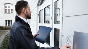 Man Pressing The Door Bell with a black cover in his hand