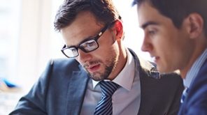 Two men reading something